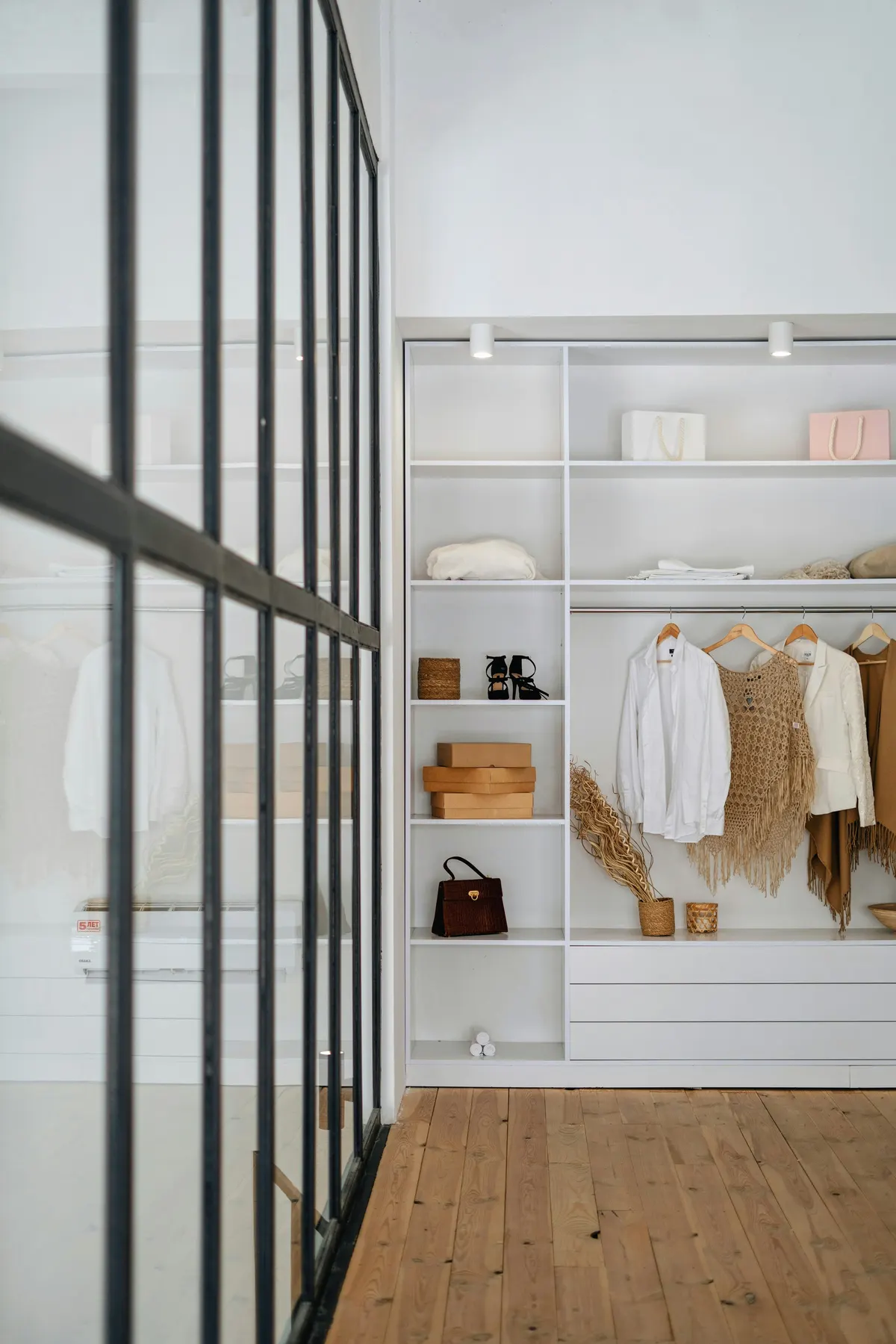 A neatly organized closet with folded stacks, baskets, and tidy hanging clothes